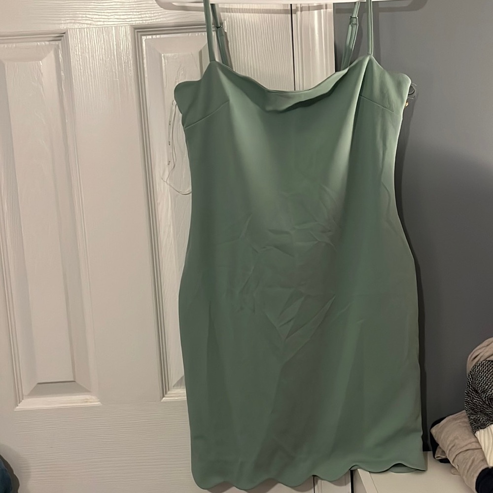 Light green scalloped skin tight dress.